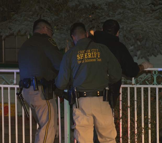 Carson City Sheriff&#039;s Office deputies arrest a man following a search warrant raid near the 3300 block of Gordonia Drive.