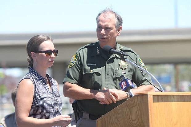 Natasha Gibson stands with Carson City Sheriff Ken Furlong while he talks about Highway 50 East on in July.  Natasha lost her two children Alexis, 8, and Colton, 3, were killed in a car accident April 22, 2011, when their father, had high levels of methamphetamine in his system. He crossed the center lane into oncoming traffic.