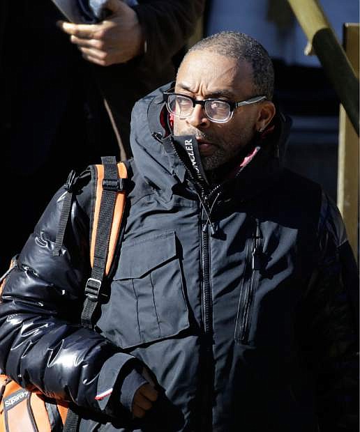Movie director Spike Lee leaves the Church of St. Ignatius Loyola following the funeral for actor Philip Seymour Hoffman, Friday, Feb. 7, 2014 in New York. Hoffman, 46, was found dead Sunday of an apparent heroin overdose. (AP Photo/Mark Lennihan)