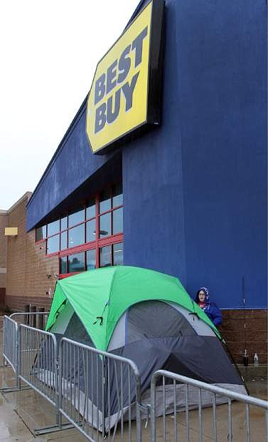 Cassie DeMontigny gets ready to spend the night outside the Best Buy Wednesday, Nov. 27, 2013 in Concord, N.H. DeMontigny is bypassing the Thanksgiving diner to be first in line when the store opens Thursday at 5:00 pm searching for a TV, an iPad 2 and &quot;maybe a camera.&quot; (AP Photo/Jim Cole)