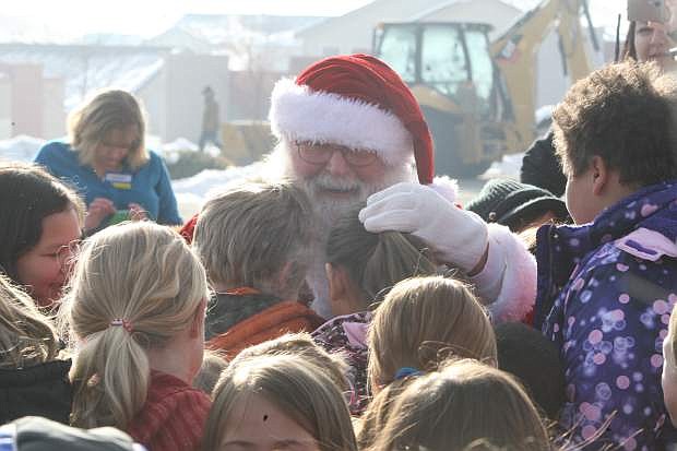 Santa greets children at the 9th annual Holiday with a Hero event on Tuesday morning at Walmart.