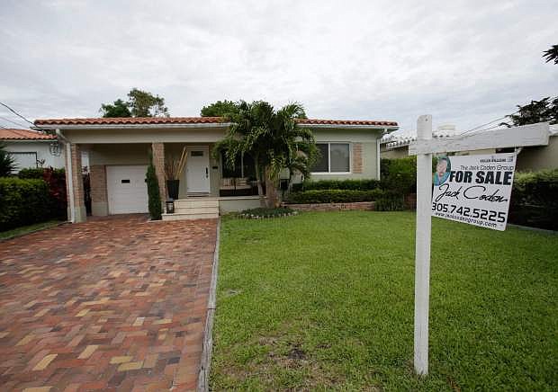In this Tuesday, May 28, 2013 photo, a single family home is shown for sale in Surfside, Fla. U.S. home prices jumped 12.2 percent in May from a year ago, the most in seven years. The increase suggests the housing recovery is strengthening. Real estate data provider CoreLogic said Tuesday, July 2, 2013, that home prices rose from a year ago in 48 states. They fell only in Delaware and Alabama. And all but three of the 100 largest cities reported price gains. (AP Photo/Wilfredo Lee)