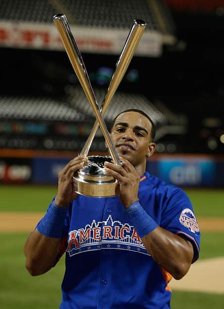 American League&#039;s Yoenis Cespedes, of the Oakland Athletics, holds the championship trophy after winning the MLB All-Star baseball Home Run Derby, on Monday, July 15, 2013 in New York. (AP Photo/Matt Slocum)