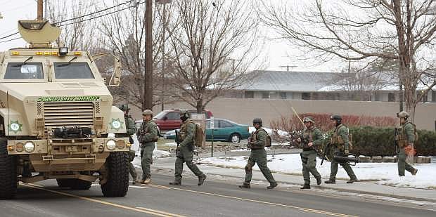 Carson City SWAT retreats after making arrests in January in the murder of Grant Watkins.