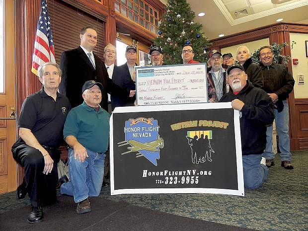 Members of the Kaempfer Crowell law frim gave Honor Flight Nevada a $3,500 donation on Friday. The money will be used to fly a Vietname veteran to Washingtion D.C.