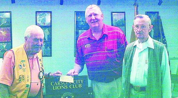 John Konvicka, center, from Honor Flight Nevada receives a $500 contribution from Carson City Lions Club Secretary and World War II veteran, Mel Cooper, left, while Lions Member and WWII veteran, Ed Block, right, looks on. The Carson City Host Lions are proud to aid Honor Flight in their mission of sending WWII veterans to Washington, D..C several time a year to visit the memorials they helped earn with their military service.