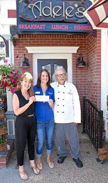 Cafe at Adele&#039;s owners Karen and Charlie Abowd give a check for $2000 to the Nevada Humane Society&#039;s Kimberly Wade Friday afternoon at the restaurant on Carson St. A May 26th &#039;Bone Appetit&#039; event donated 25% of the day&#039;s total sales to the Humane Society.