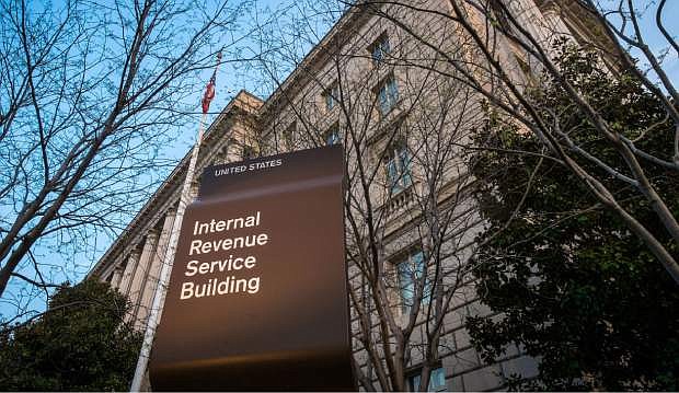 FILE - In this April 13, 2014 file photo, the Internal Revenue Service Headquarters (IRS) building is seen in Washington. Thieves used an online service provided by the IRS to gain access to information from more than 100,000 taxpayers, the agency said Tuesday. The information included tax returns and other tax information on file with the IRS. The IRS said the thieves accessed a system called &quot;Get Transcript.&quot; In order to access the information, the thieves cleared a security screen that required knowledge about the taxpayer, including Social Security number, date of birth, tax filing status and street address.  (AP Photo/J. David Ake, File)