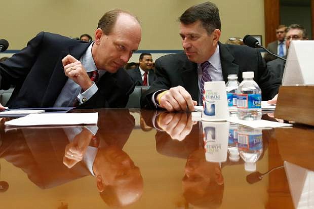 Gregory Kutz, Assistant Inspector General for Audit, Treasury Inspector General for Tax Administration, left, talks with Faris Fink, Commissioner, Small Business and Self-Employed Division, Internal Revenue Service, on Capitol Hill in Washington, Thursday, June 6, 2013, prior to testifying before the House Oversight and Government Reform Committee hearing regarding IRS conference spending.  (AP Photo/Charles Dharapak)