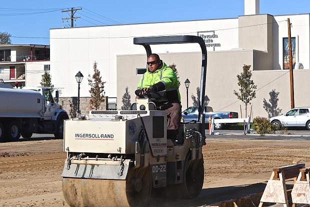 Carson City public works employee Steve Salazar is seen preparing the Arlington Square ice skating rink Thursday which is set to open on Friday November 27th.