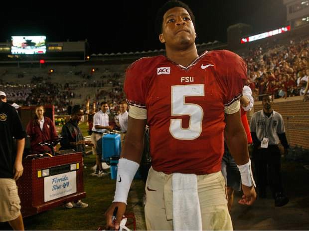 Florida State quarterback Jameis Winston (5) walks off the field after an NCAA college football game against Idaho on Saturday, Nov. 23, 2013 in Tallahassee, Fla. Florida State beat Idaho 80-14. (AP Photo/Phil Sears)