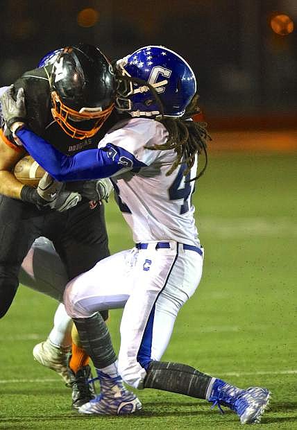 Carson linebacker Ikela Lewis (42) brings down a Douglas ball carrier on October 29th.