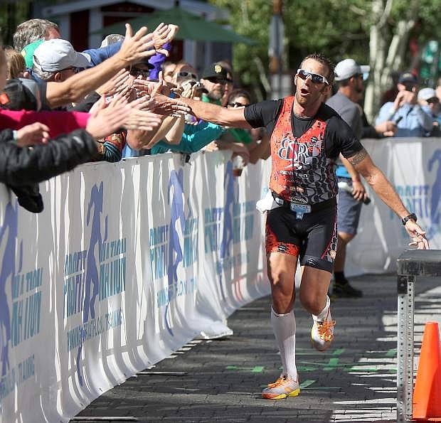 Australian Chris McDonald receives high-fives as he nears the finish line of the inaugural Ironman Lake Tahoe in 2013.