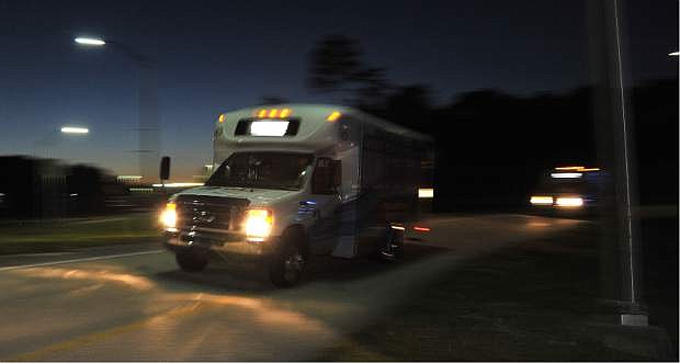 Shuttles used to move people out of Jacksonville International Airport drive by Tuesday, Oct. 1, 2013, in Jacksonville, Fla. The airport was evacuated after authorities found two suspicious packages. (AP Photo/The Florida Times-Union, Bruce Lipsky)