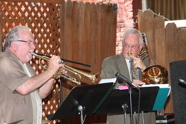 Carson City Rascals Wayne Theriault, trumpet, and CJ Birch, trombone, perform at the Comma Commons Saturday afternoon.