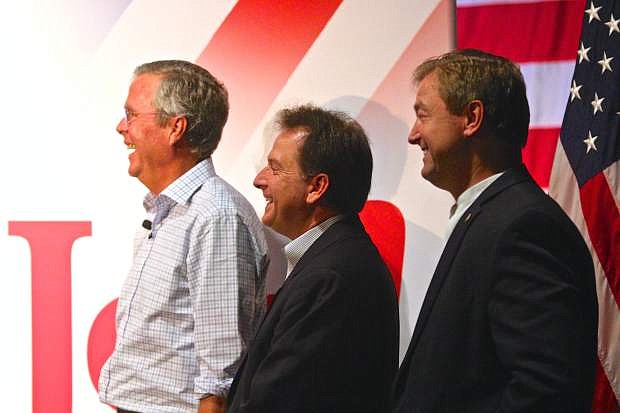 Jeb Bush, Brian Krolicki and Dean Heller laugh as Mark Amodei speaks prior to Mr. Bush taking the stage Friday in Carson City.