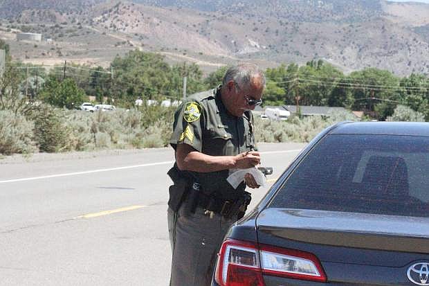 Sgt. Scott McDaniel issues a speeding citation for a woman on Arrowhead Drive in Carson City during the speeding event for Joining Forces Tuesday.