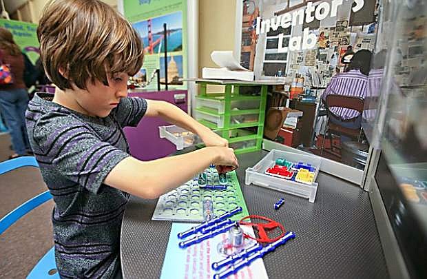 Will Contine, 10, explores part of the &quot;Discover Tech: Engineers Make a World of Difference&quot; exhibit at the Carson City Library.