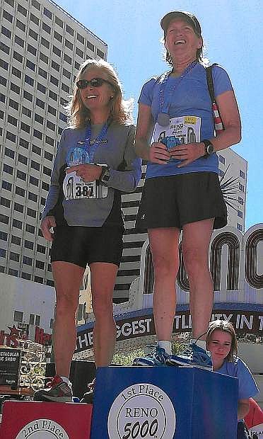 Fallon resident De Vere Karlson, right, stands atop the podium after she won her age group in Sunday&#039;s Reno Downtown River Run half marathon. She will compete Monday in the 118th Boston Marathon.