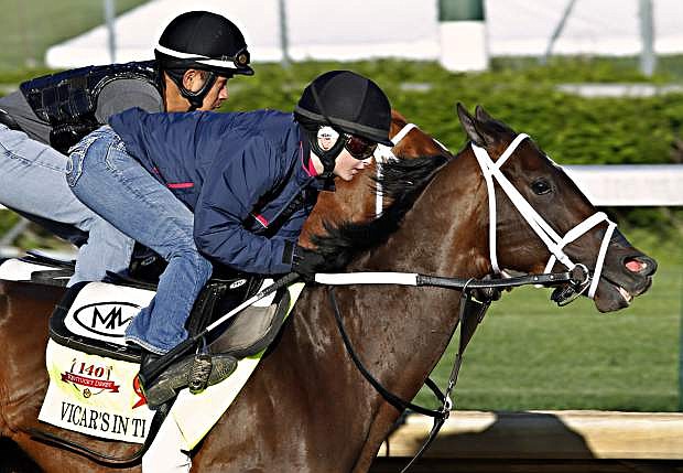 Jockey Rosie Napravnik, right, works Kentucky Derby hopeful Vicar&#039;s in Trouble with a stablemate at Churchill Downs in Louisville, Ky., Saturday, April 26, 2014.  (AP Photo/Garry Jones)