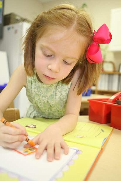 Ellie Ruffner, 5, works on her portrait at Carson Montessori on Thursday morning.
