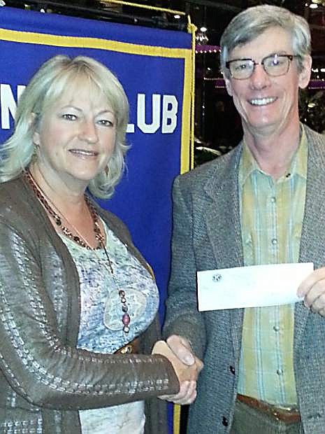 Cheryl Knight, president of Carson City Kiwanis, presents Chris Bayer of Court Appointed Special Advocates with a check for $500 to support CASA and children in the juvenile court system.