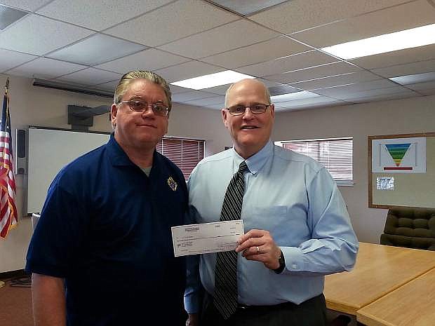 Dennis W. Stark and Superintendent Keith Savage hold a check presented to the Lyon County School District from Knights of Columbus Council 6688.