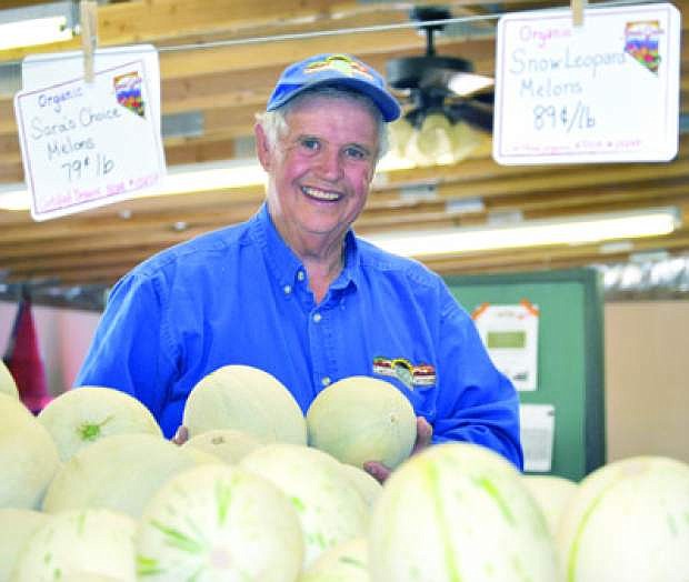 Rick Lattin, a member of the Cantaloupe Festival committee, shows the Hearts of Gold melons. The Cantaloupe Festival and Country Fair decided in November to merge into one event.