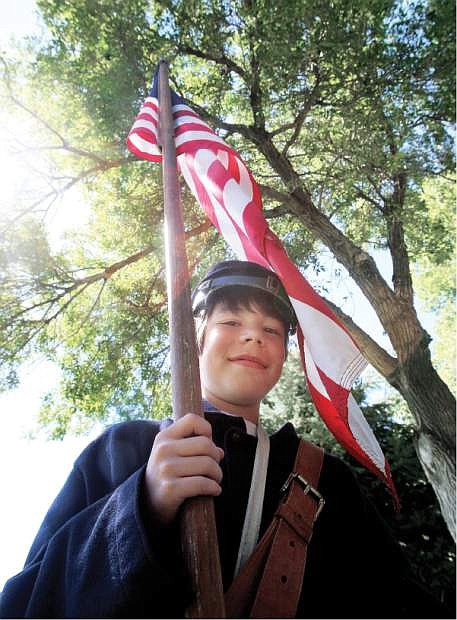 Comstock Civil War Re-enactor Aiden Cluff, 12, bears the flag for the Union troops.