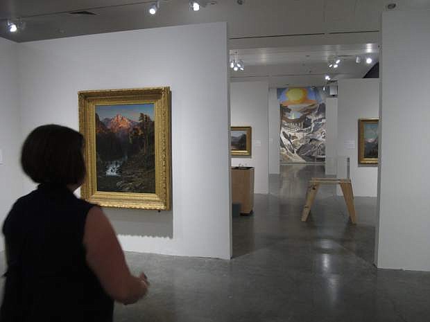 Ann Wolfe, senior curator of the Nevada Museum of Art, stands in front of the new exhibit, ``Tahoe: A Visual History&quot;  on Aug. 18, 2015 in Reno, Nev.  For the first time, all 15,000-square feet of the museum&#039;s gallery space is devoted to a single theme with 400 objects by 175 painters, photographers, architects, basket weavers and sculptors. (AP Photo/Scott Sonner)
