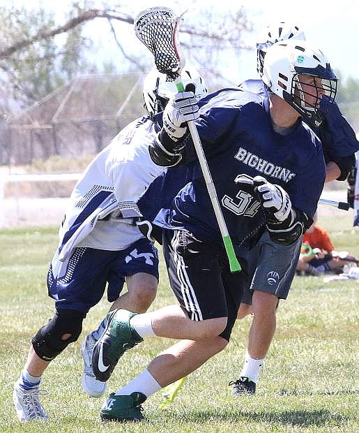 Bighorns lacrosse player Trent Thorn drives past a North Tahoe defender during Oasis&#039; 12-2 win on Saturday. The Bighorns play in the under-15 state tournament this weekend as the North&#039;s No. 1 seed.