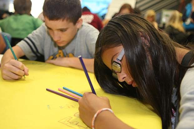 Erika Bolanos, 13 and Tylor Munoz, 13, create artwork of their names on Wednesday at the Boys &amp; Girls Clubs of Western Nevada.