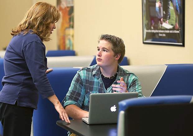 Out of School Time Coordinator Molly Walt talks with Carson High student Sam Wilson, 16, in the Digitorium at the Carson City Library in Carson City, Nev., on Thursday, May 27, 2015. Wilson used the free library wi-fi to work on his resume to help get a job.