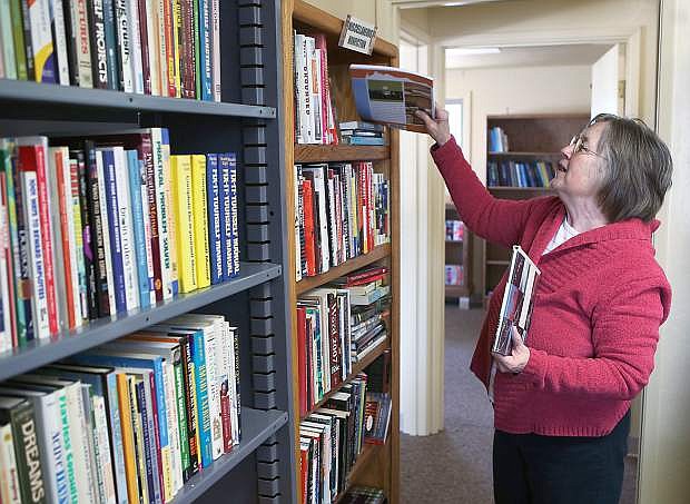 Volunteer Marla Johnson stocks the shelves of the new Browsers Corner Bookstore across the parking lot from the Carson City Library. A grand opening of the new location, run by the Friends of the Carson City Library, will be 9:30 a.m. April 12 at 711 E. Washington St.