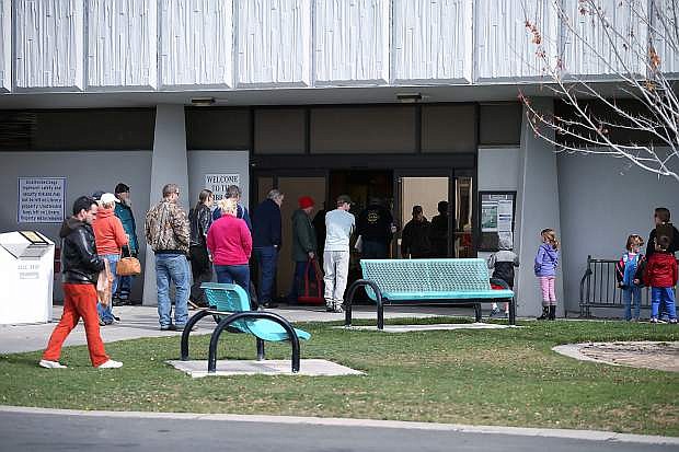 Patrons line up for the doors to open at the Carson City Library, in Carson City, Nev., on Tuesday, April 14, 2015. In an effort to better serve its patrons, the library will open on Sundays starting in June.