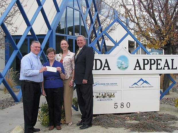 Janet Whitemore, second from left, accepts a $5,000 check from Nevada Appeal advertising director and The Record-Courier publisher Pat Bridges, Nevada Appeal key account manager Tonya Champa and Nevada Appeal publisher Mark Raymond.