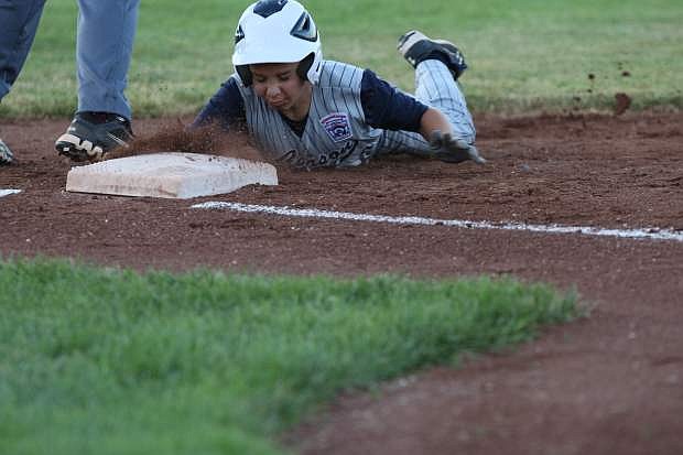 Joe &#039;Sausage&#039; Tonino of Carson dives back to first base in an attempted pick off by the North Summerlin pitcher Saturday evening at Governor&#039;s Field.