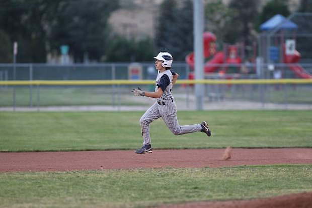 Josh Buckam rounds second base and heads for third in a game against Reno on Tuesday night.