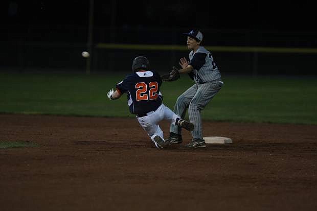 Carson shortstop Wyatt Rooker attempts to tag out Centennial player Dawson Martin Thursday night at Governor&#039;s Field.