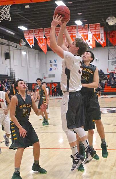 Douglas senior Jace Hart pushes one towards the bucket Friday night in a loss to Manogue.