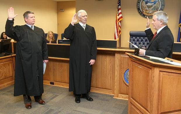 Nevada Chief Justice James Hardesty, right, swears in District Court Judge James Wilson and District Court Judge James Russell on Monday.