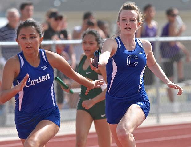 Carson senior Sahara Winder exchanges the baton with junior Alison Greene during the girl&#039;s 4x100 relay event at the Jim Frank Track Complex earlier this season.