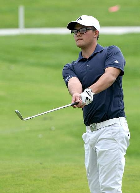 Dalton Butler chips onto the 7th hole green at Dayton Valley Golf Course on Monday.