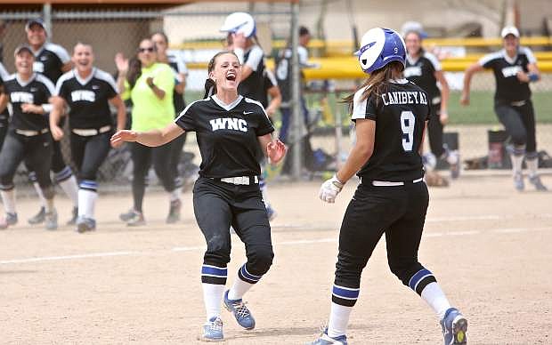 WNC&#039;s Kristina George rushes onto the field to celebrate with Gabrielle Canibeyaz Friday after Canibeyaz drove in the winning run during the first game of a triple-header with CSI at Edmonds Sports Complex.