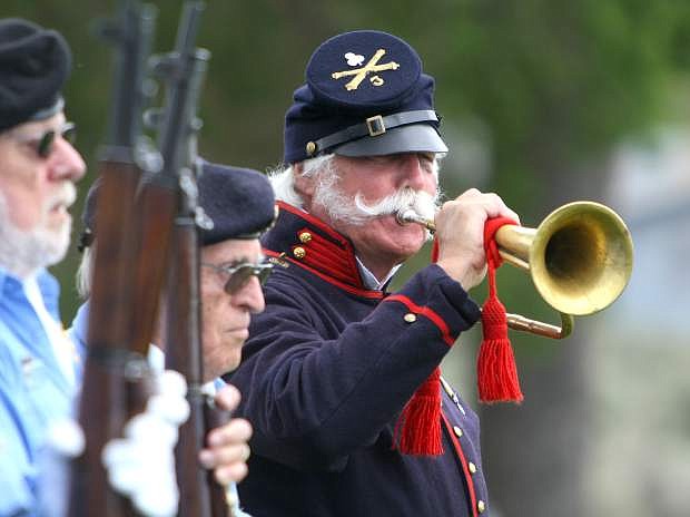 Ray Ahrenholz plays &quot;Taps&quot; at the Memorial Day ceremony at Lone Mountain Cemetery on Monday.