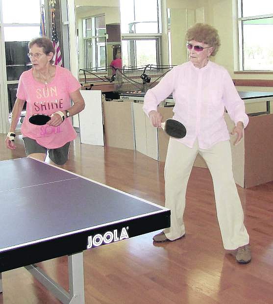Louisa Vanderlinden, right, returns a shot during a Tuesday morning doubles match with Marianne Nevling of Carson Valley Table Tennis Club seniors play at the Douglas County Community Center.