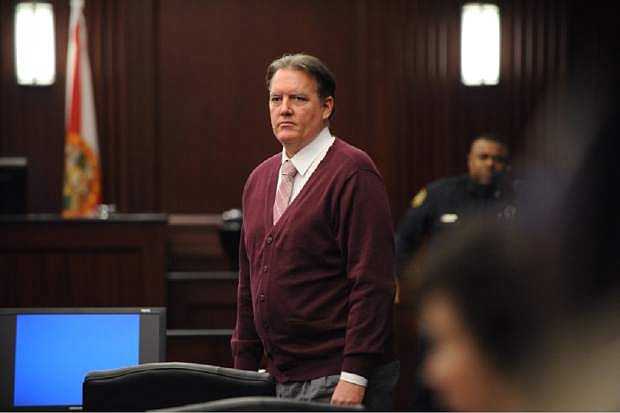 Michael Dunn watches as his family leave the courtroom during a morning break. The third day of the murder trial of Dunn for the shooting death of Jordan Davis opened early Saturday Feb. 8, 2014. The case is being heard in the courtroom of acting Circuit Judge Russell Healey in the Duval County Courthouse in Jacksonville, Fl. (AP Photo/The Florida Times-Union, Bob Mack, Pool)