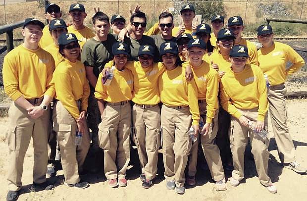 JROTC students who attended a week of training at Camp Pendleton in Southern California take a photo with three Marines (in green) who worked with them throughout the week.