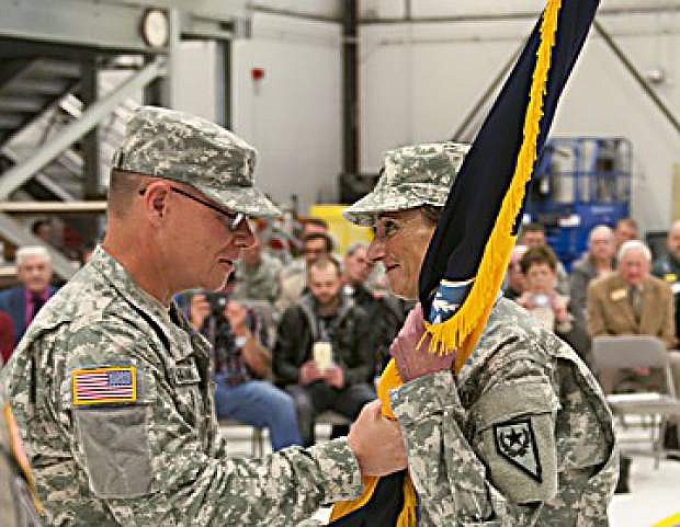 Brig. Gen. Michael Hanifan hands the colors off to Col. Joanne Farris, signaling the change of command for the 991st Multi-Functional Brigade. Farris is the first female brigade commander in the state of Nevada.