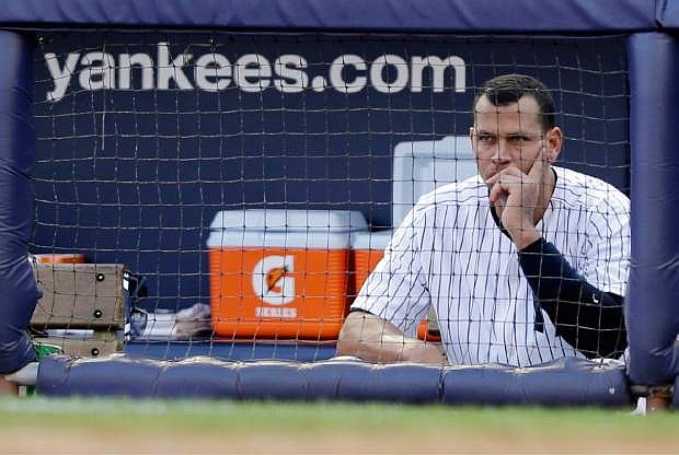 FILE - In this Oct. 14, 2012 file photo, New York Yankees&#039; Alex Rodriguez sits in the dugout after striking out in the second inning of Game 2 of the American League championship series against the Detroit Tigers in New York. Major League Baseball has told the union which players it intends to suspend in its drug investigation and which ones will receive lengthier penalties for their roles in the Biogenesis case. (AP Photo/Matt Slocum, File)